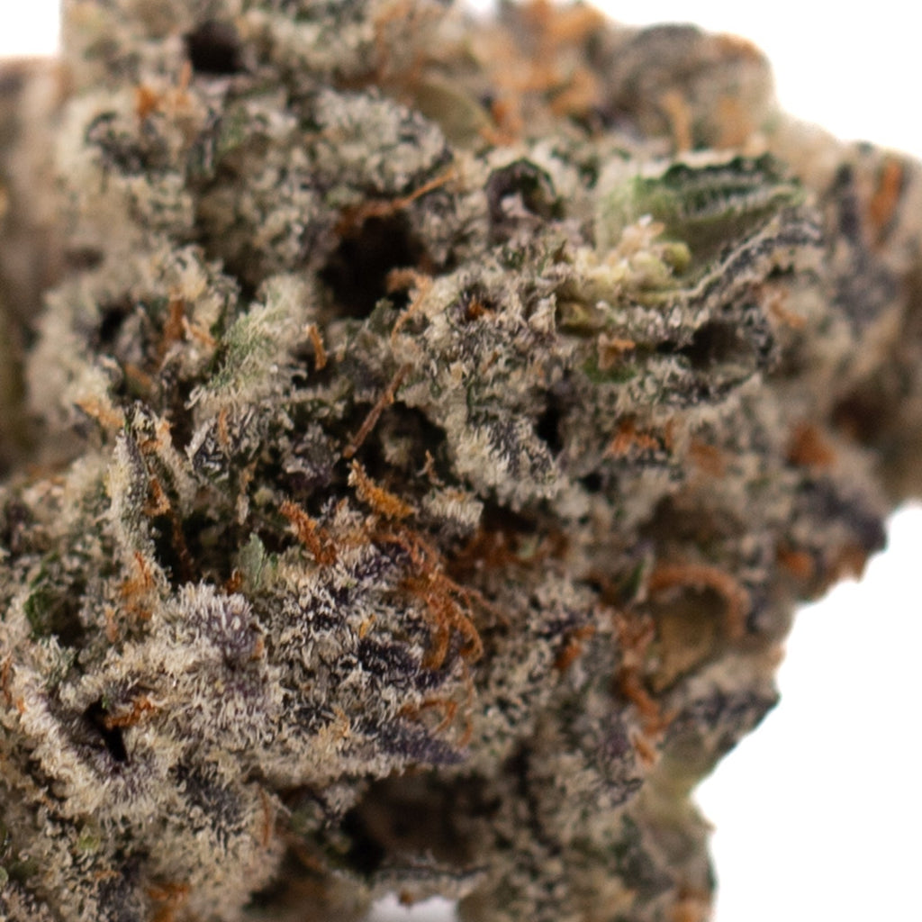 Close-up of Granny Crack Sour Apple THCa Flower with trichomes and vibrant hues